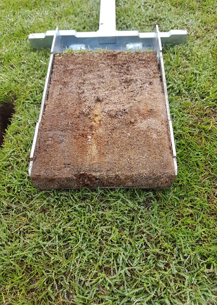 Section of lawn dug out with soil sampler