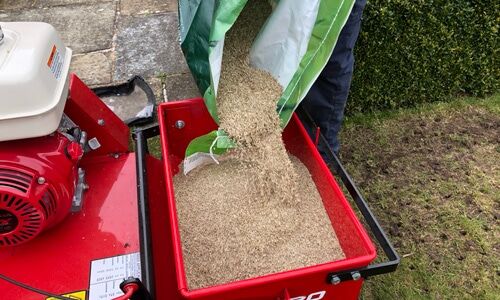 Grass seed being poured into a seeding machine