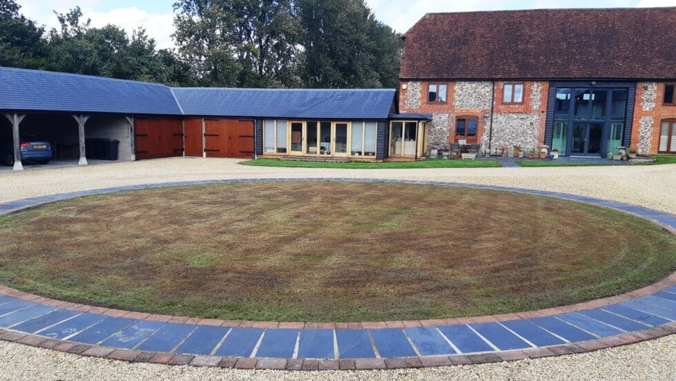 Circular patch of lawn outside house