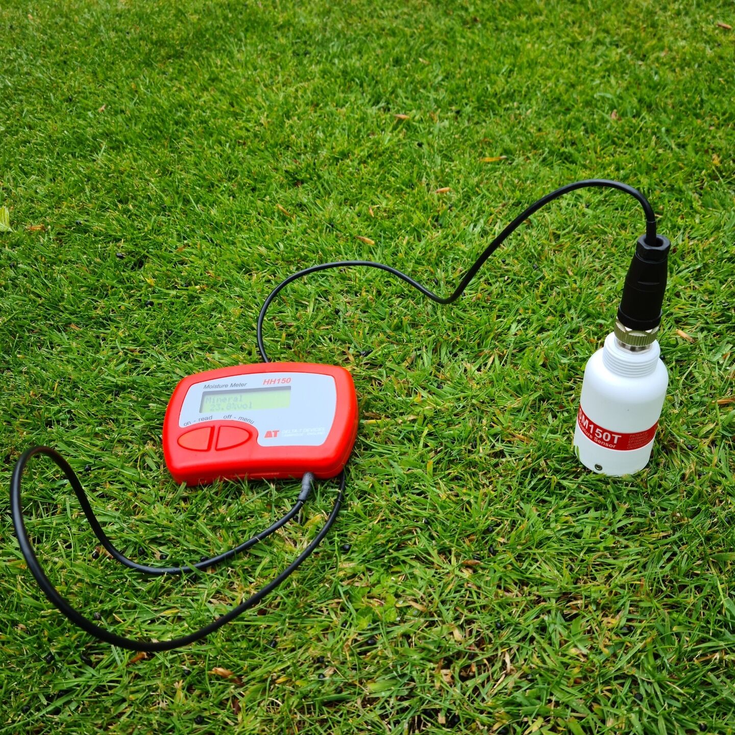 An electronic measuring device set on a lawn